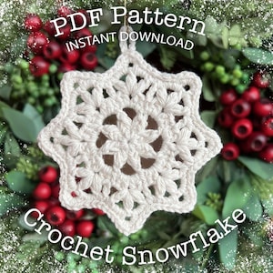 May include: A white, crocheted snowflake ornament with a detailed floral design. The ornament is hanging against a backdrop of greenery and red berries. Text on the image reads "PDF Pattern Instant Download" and "Crochet Snowflake".