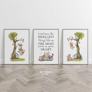 May include: Three framed wall art prints featuring Winnie the Pooh characters. The left print shows Pooh and Tigger on a swing in a tree. The center print displays the text Sometimes the SMALLEST things take up THE MOST room in your HEART. The right print shows Pooh holding a balloon.