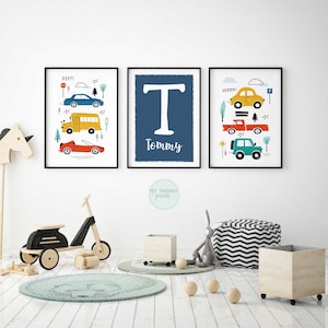 May include: Three framed prints with a blue, yellow and red colour scheme. The prints feature illustrations of cars, trucks and a school bus. The middle print has a large white letter "T" and the name "Tommy" written below it.