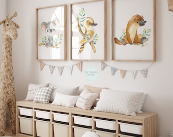 May include: Three watercolor animal prints featuring a koala, a kookaburra, and a platypus. The prints are framed in natural wood and hung on a white wall above a wooden bench with storage bins.