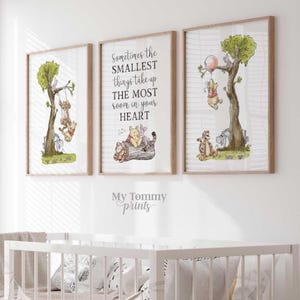May include: Three framed wall art prints featuring Winnie the Pooh characters. The left print shows characters on a swing, the center print displays the text Sometimes the SMALLEST things take up THE MOST room in your HEART, and the right print shows characters with a balloon.