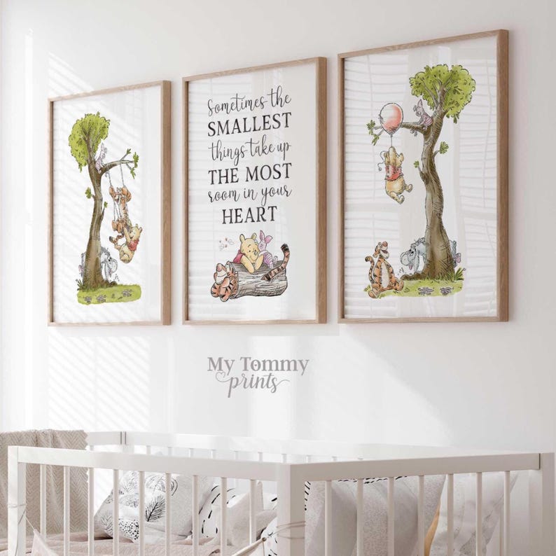 May include: Three framed wall art prints featuring Winnie the Pooh characters. The left print shows characters on a swing, the center print displays the text Sometimes the SMALLEST things take up THE MOST room in your HEART, and the right print shows characters with a balloon.