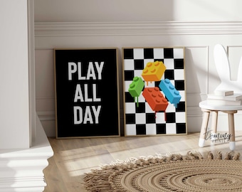May include: Two black and white framed prints with a black and white checkered background. One print has the text "PLAY ALL DAY" and the other print has colorful toy blocks on a checkered background.