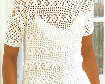 May include: White crochet top with a loose fit and short sleeves. The top features a delicate, openwork design.