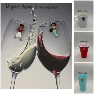 May include: Two wine glasses with magnetic charms of Aladdin and Jasmine. One glass has white wine, the other red. The text "Magnetic charms for: wine glasses" is at the top. Additional images show a coffee mug, a red Solo cup, and a blue plastic cup.