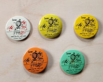 Love is... papering the wall with "I Love You", By Kim, metal buttons,  SOLD INDIVIDUALLY, vintage, pins, circa 1970's