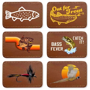 May include: Six brown leather patches with different fishing and hunting themes. The patches feature illustrations of fish, a fly fishing lure, a pheasant, and text that says "Out for Trout", "Bass Fever", and "Catch It!"