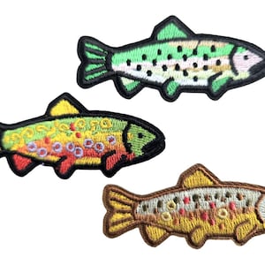 May include: Three embroidered fish patches in green, yellow, and brown. The patches feature detailed stitching, showcasing the fish's scales and fins. The patches are ideal for adding to clothing or accessories.