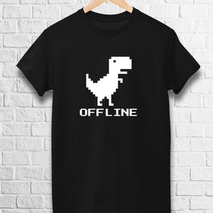 May include: Black t-shirt with a white pixelated dinosaur and the word "OFFLINE" in white pixelated letters.