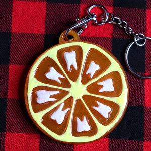 OFMD &quot;The Teeth Don&#39;t Go Back In?&quot; Charm | Our Flag Means Death Orange Keychain