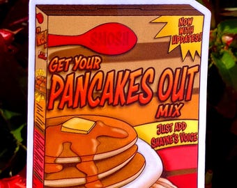 以下が含まれることがあります： シロップとバターのかかったパンケーキの山が描かれたステッカーで、「Pancakes Out Mix」と表示されています。「Get Your Pancakes Out」と「Just Add Shayne's Voice」の文字も含まれています。ステッカーは茶色、オレンジ色、赤色の配色です。