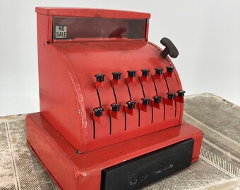 Gold With Black Print and Designs With Red Bottom Vintage Toy Cash Register Black and Red Plastic Handle Push Buttons to Raise Numbers.
