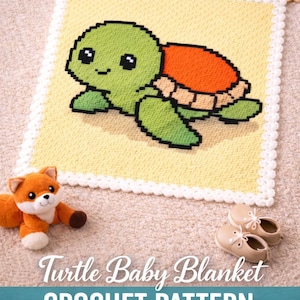 May include: A crocheted baby blanket featuring a pixelated turtle design in green, orange, and tan. The blanket has a yellow background and a white scalloped border. A plush fox toy and baby shoes are in the foreground.