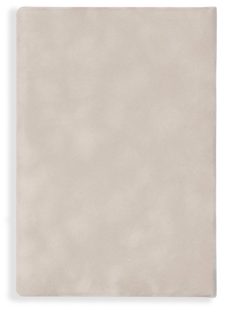 May include: A plain, off-white, textured notebook cover.