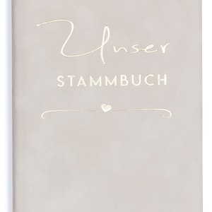 May include: A light gray book with the words "Unser Stammbuch" in gold lettering. A small heart symbol is above a decorative line.