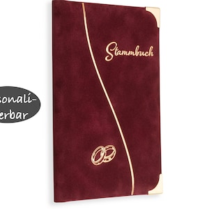 May include: Burgundy velvet-covered book with gold lettering that reads "Stammbuch" and a gold design of two interlocking rings. The book is personalized.