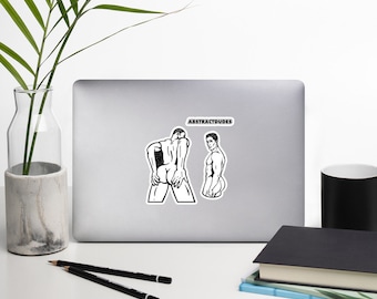 May include: Two black and white line drawings of men on a white laptop sticker. The text "ABSTRACTDUDES" is above the drawings.
