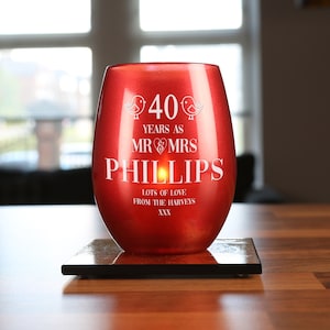 May include: Red glass candle holder with the text "40 Years as Mr & Mrs Phillips" and "Lots of Love from the Harveys xxx" in white lettering.