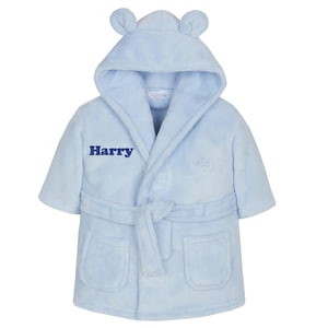 May include: A light blue baby bathrobe with a hood and bear ears. The robe has a belt, pockets, and the name "Harry" embroidered on the front. The robe is made of a soft, plush material.