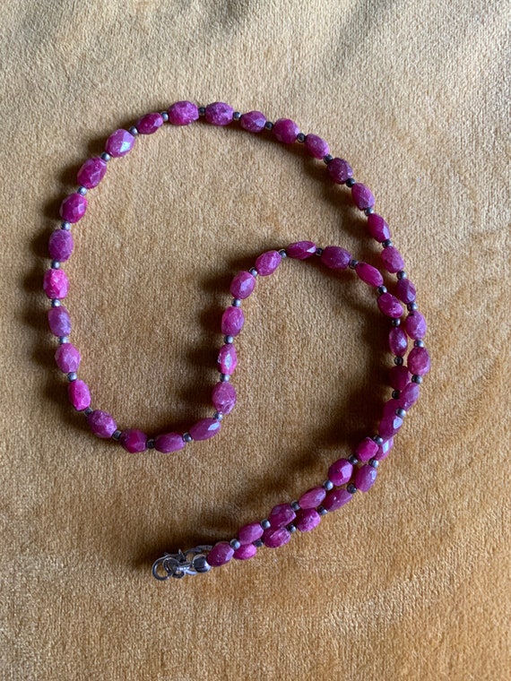 Dainty hand strung choker featuring faceted raw ruby and sterling silver beads