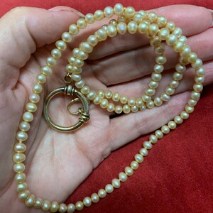 Vintage hand knotted strand of pearls featuring large gold Vermeil clasp