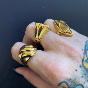 A trio of gold vermeil cocktail rings never worn one featuring a Tigers eye stone