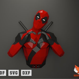 Puede incluir: Un modelo de papel de Deadpool en rojo y negro haciendo un corazón con las manos. El modelo está en estilo 3D y tiene un diseño detallado. El fondo es gris.