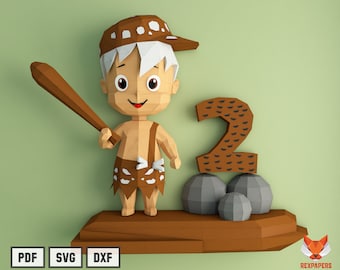 May include: A papercraft model of a cartoon caveman holding a club, standing on a wooden platform with a number 2 made of paper. The number 2 is decorated with a brown pattern and is sitting on three gray rocks.