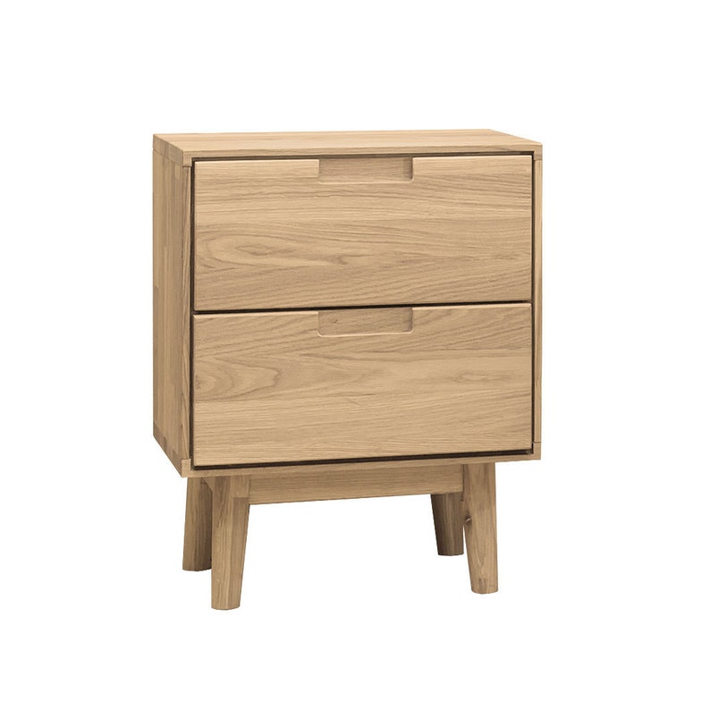 May include: A light-colored wooden nightstand with two drawers and a minimalist design. The nightstand has a rectangular shape, with recessed drawer pulls and four angled legs. The wood grain is visible, giving it a natural look. A modern piece of bedroom furniture.