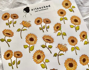 Peut inclure: Feuille d'autocollants de tournesols. Chaque autocollant présente une illustration détaillée d'un tournesol avec des pétales jaunes et un centre brun. Les autocollants ont des tiges et des feuilles vertes. La feuille porte le texte "artsocked just sunflowers!"