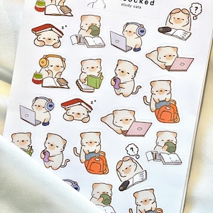 May include: A sticker sheet featuring multiple illustrations of study cats. The cats are depicted with books, laptops, headphones, and backpacks. The sticker sheet has the text "artsocked study cats".