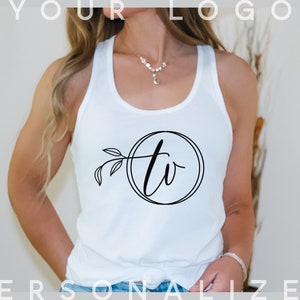 May include: White tank top with a black circle design featuring the letters "tv" in a script font with a small floral design to the left of the circle.