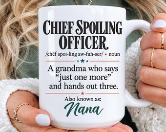 May include: A white ceramic mug featuring black text that reads Chief Spoiling Officer, followed by a phonetic pronunciation, and the definition: A grandma who says just one more and hands out three. The text also includes the phrase Also known as: Nana.