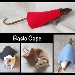 May include: Three rats wearing different colored capes. The first rat is wearing a red cape, the second rat is wearing a black cape, and the third rat is wearing a blue cape. The image is titled "Basic Cape".