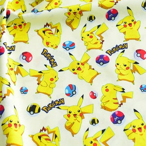 May include: Cream-coloured fabric featuring a repeating pattern of yellow Pikachu characters, red and white Pokeballs, and the word "Pokemon" in blue. Ideal for crafting, the fabric has a playful and vibrant design.