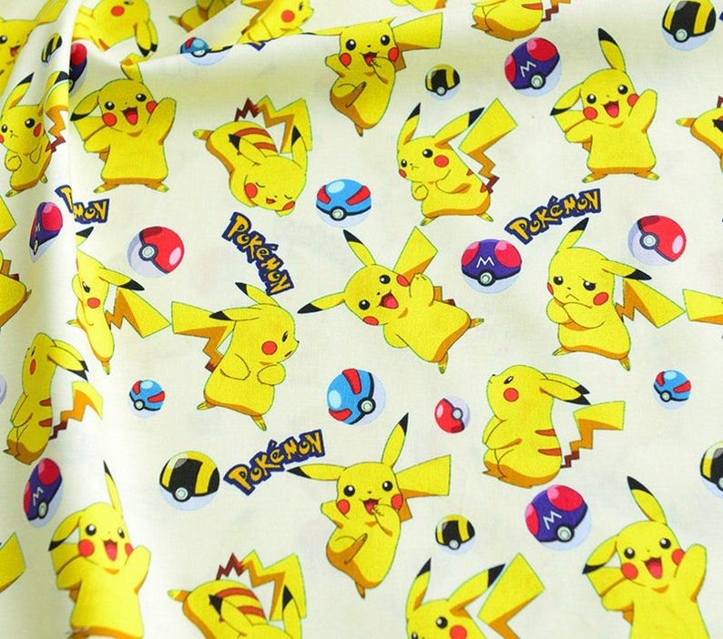 May include: Cream-coloured fabric featuring a repeating pattern of yellow Pikachu characters, red and white Pokeballs, and the word "Pokemon" in blue. Ideal for crafting, the fabric has a playful and vibrant design.