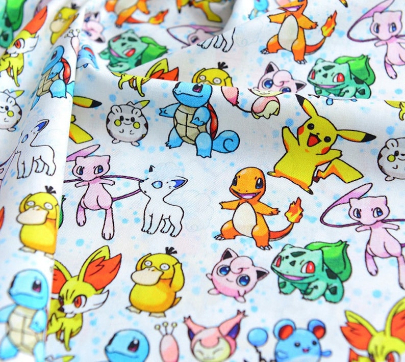 May include: White fabric with a repeating pattern of colourful cartoon characters. The design includes various creatures in shades of yellow, blue, green, pink, and orange. The fabric has a soft, slightly textured appearance.