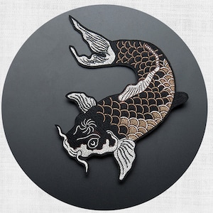 May include: Black and white embroidered iron-on patch of a koi fish with gold scales. The fish is swimming to the right and has a white fin and tail.