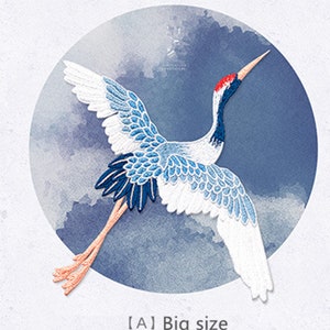 May include: A blue and white embroidered crane with a red head and long orange legs. The crane is flying against a blue watercolour background with a white circle around it. The text "[A] Big size" is below the crane.