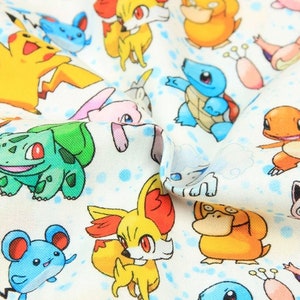 May include: White fabric with a repeating pattern of colourful cartoon characters, including Pikachu, Bulbasaur, and Squirtle. The design includes blue polka dots, creating a playful and vibrant aesthetic. Suitable for crafting or clothing.