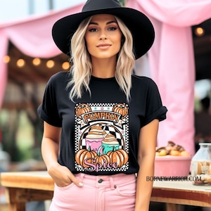 May include: Black t-shirt with a graphic of a pumpkin spice latte and the text "Pumpkin Spice".