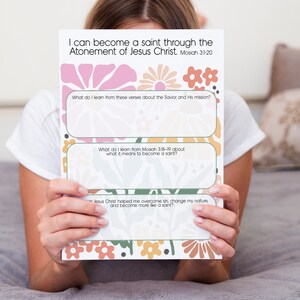 May include: A printable worksheet with a floral design and the text "I can become a saint through the Atonement of Jesus Christ. Mosiah 3:1-20". The worksheet has three sections with questions about the Savior and His mission, what it means to become a saint, and how Jesus Christ helped overcome sin.