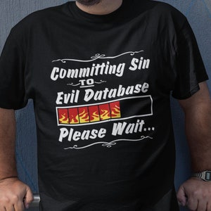 May include: A black t-shirt with a white graphic that says "Committing Sin to Evil Database" with a progress bar that is filled with flames and the text "Please Wait..."