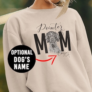 May include: Beige sweatshirt with the text "Pointer Mom" in black lettering. A black and white dog image is inside the "O" of "Mom". The text "Cooper" is written in cursive below the "Mom".