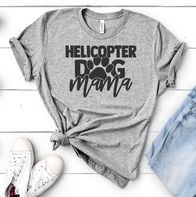 May include: Grey t-shirt with the text "Helicopter Dog Mama" in black lettering with a paw print in the middle of the word "Dog".