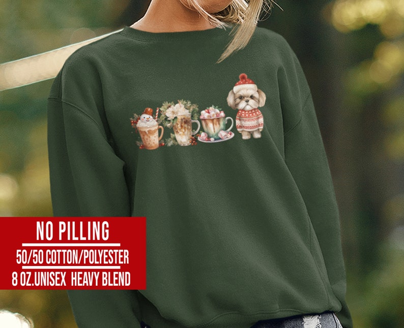 May include: A dark green sweatshirt with a festive design featuring a dog wearing a Santa hat and surrounded by hot chocolate and marshmallows. The text "NO PILLING 50/50 COTTON/POLYESTER 8 OZ.UNISEX HEAVY BLEND" is printed on the bottom of the sweatshirt.