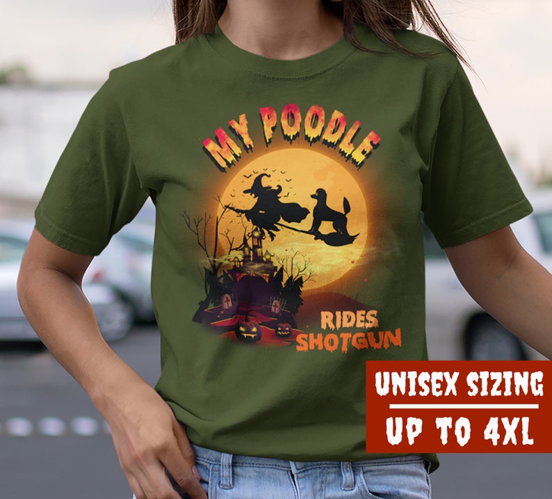 May include: Green t-shirt with a graphic of a witch riding a broom with a poodle in front of a full moon. The text "My Poodle Rides Shotgun" is printed on the shirt. Unisex sizing up to 4XL.