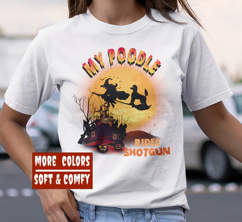 May include: White t-shirt with a graphic of a poodle riding a witch's broom in front of a full moon. The text "My Poodle Rides Shotgun" is printed on the shirt.