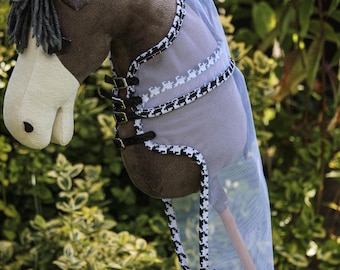 May include: A brown and white horse head with a black and white checkered fly mask. The mask is made of mesh and has a black strap with buckles.