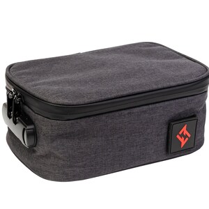 May include: A grey zipped pouch with a black zipper and a black handle. The pouch has a black and red logo on the side that says "JET".
